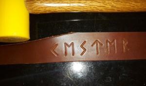 chestnut brown leahter with vking runes tooled into it
