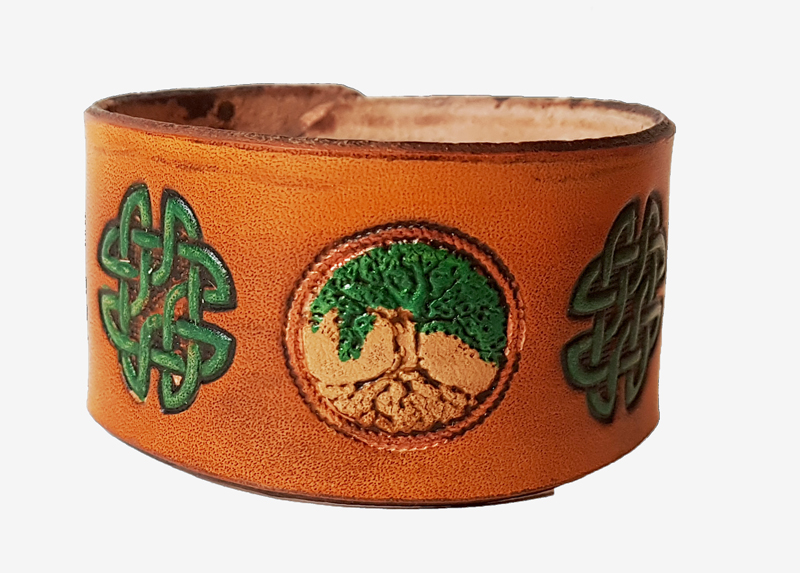 a hand cut leather cuff with tree of life motif and celtic knot stamps